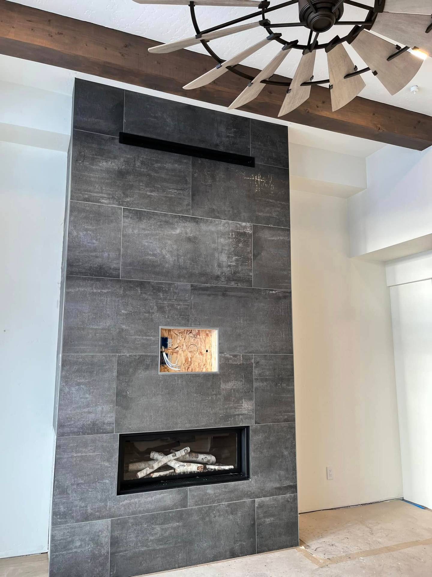 Charcoal tile fireplace wall with crisp painted walls